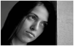 Human Trafficking: image of a girl with her head against the wall.